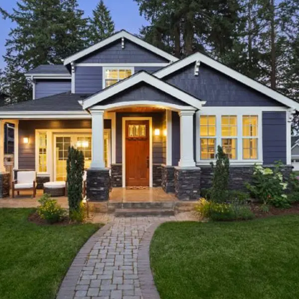 A house with a brick path leading to the front door.