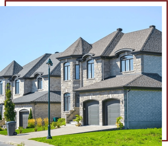 A row of houses with a green lawn in front.