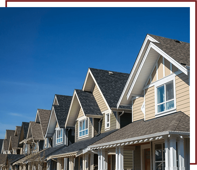 A row of houses with a blue sky in the background.