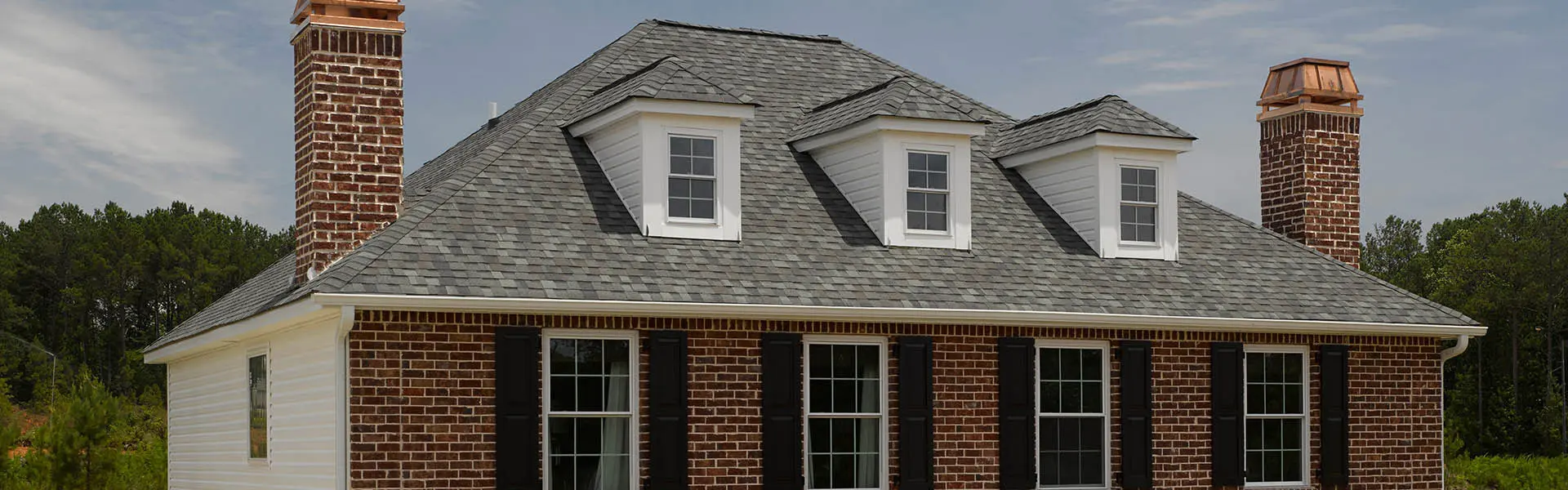 A house with two windows and a roof that has been cut off.