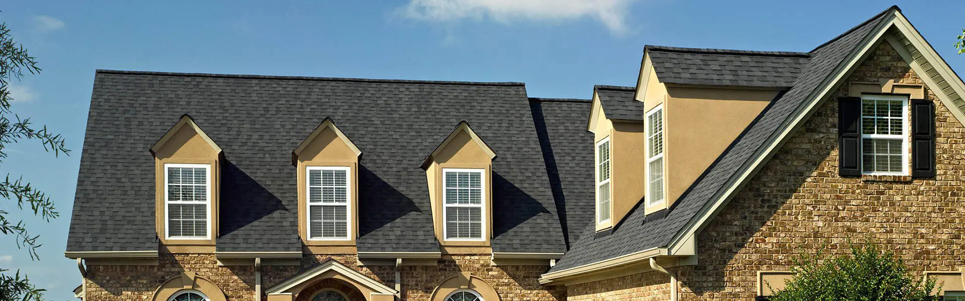 A house with a lot of windows and some black shingles