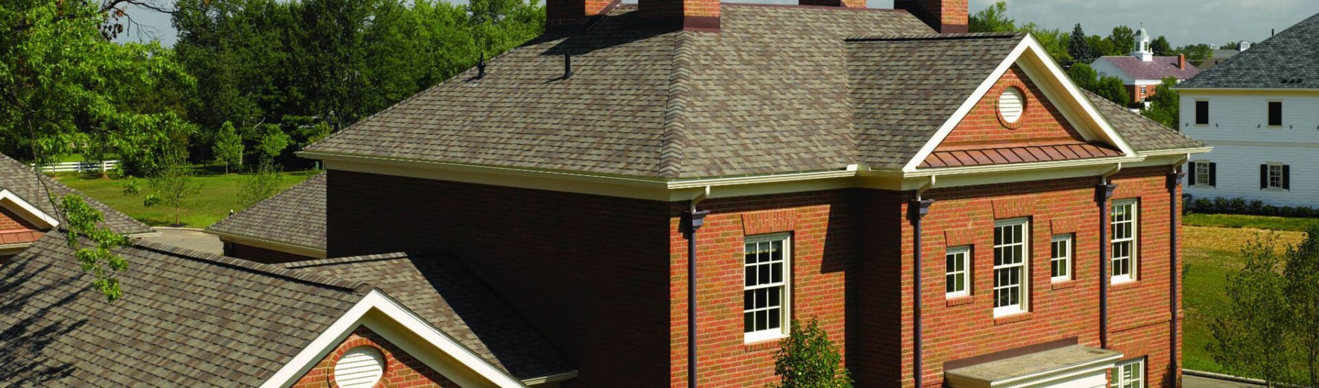 A brick house with a roof that has been cleaned.