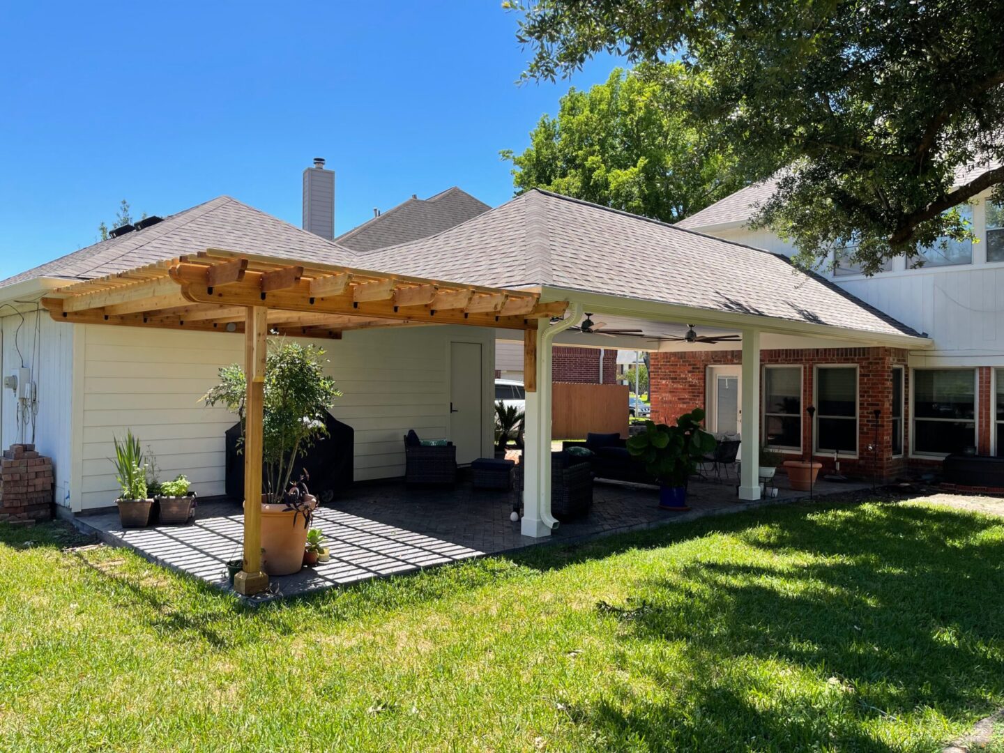 A patio with an awning and a gazebo.